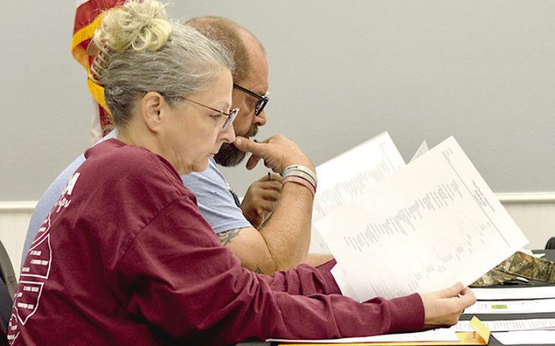 Aldermen Janice Barton and Lee Gibbs study the city’s financial reports at the Tenaha city council meeting last week. David Danley | Light and Champion