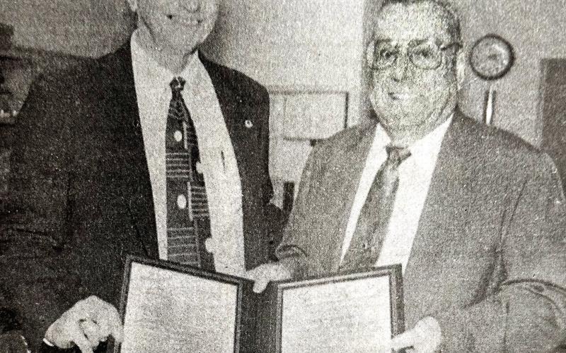 Retiring Tenaha Postmaster Jack C. Christian (right) was presented with a letter and special certificate commemorating his years of service when a retirement reception was held in his honor last week. Making the presentations was Dennis Rogers of Tyler, manager of Post Office Operations for the Dallas District. (Staff photo by Candice Velvin)