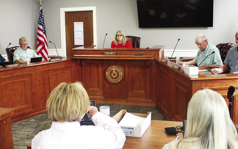 The Shelby County Commissioners Court listens as County Treasurer Ann Blackwell (bottom, left) reviews the county’s weekly expenses. Lisa White | Light and Champion