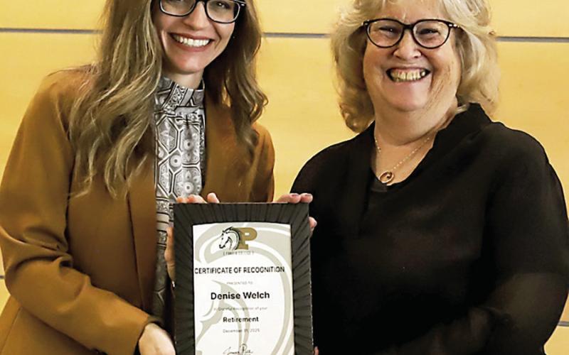 Dr. Jessica Pace, President of Panola College (left), presents recent retiree Denise Welch with a plaque commemorating her 17 years of ser - vice to the college. Submitted | Light and Champion