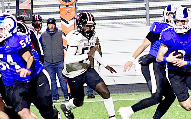 Cooper Bragg takes the handoff from Trenton Runnels (1) while Karson Rogers (54) pulls out to lead the blocking for him while a San Augustine Wolf pursues from behind. SAVANNAH JORDAN JHS | LIGHT AND CHAMPION