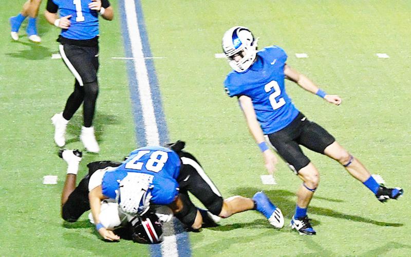 Joaquin Ram Connor Rios (87) takes down a San Augustine Wolf player withTrenton Runnels (1) and Cooper Bragg (2) closing in to assist. KELSI WOOD JHS | LIGHTAND CHAMPION