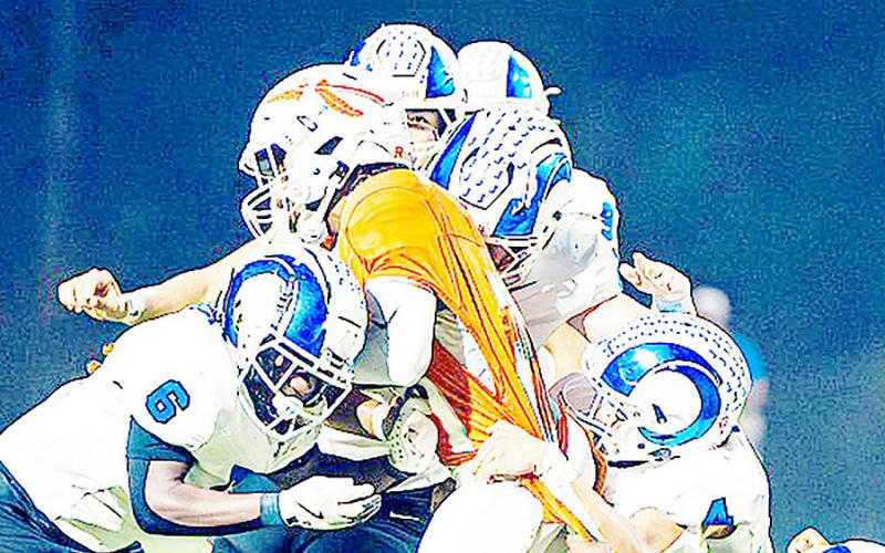 A group of Rams defenders gang up on a Honey Grove runner in yet another display of the defensive dominance Joaquin exerted as they brought the 10-1 Warriors’ season to an abrupt ending. Lister Publishing | Light and Champion