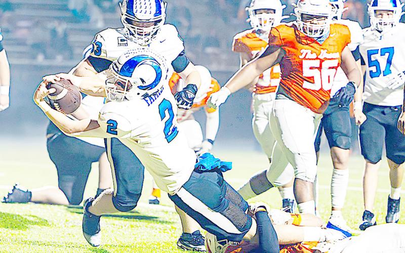 Ram Cooper Bragg lunges toward the goal line for a touchdown as a Warrior tries to hold him back to no avail. Lister Publishing | Light and Champion