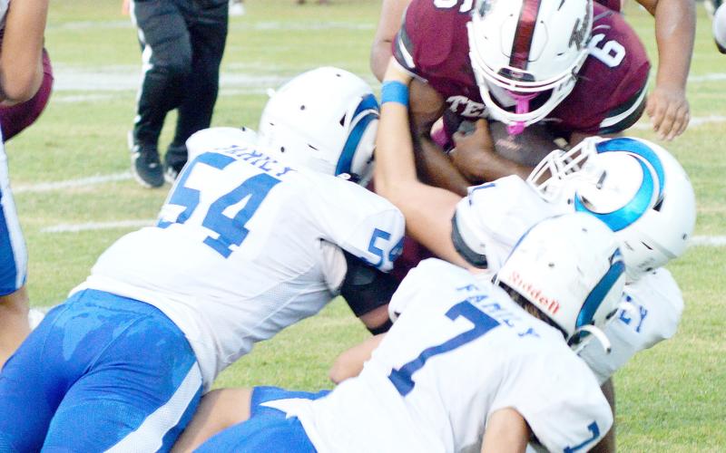 Kori Miles fights for yardage while being wrapped up by Joaquin defenders. David Danley | Light and Champion