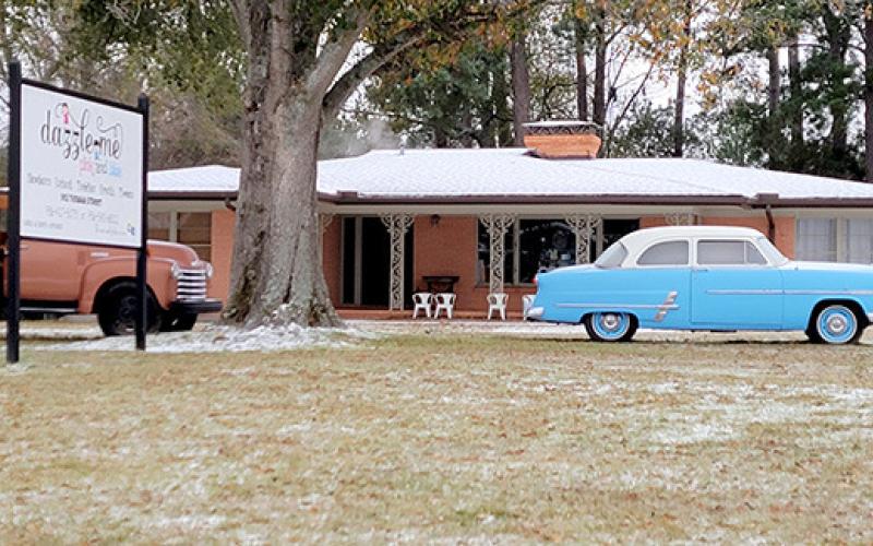 Local businesses took a snow day or two. Pictured is Dazzle Me Pink and Blue and the pair of vintage venicles that decorate covered in ice and snow. Photo Dennis Phillips | The Light and Champion