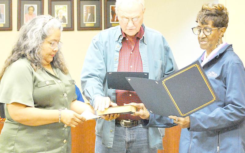 Esther Elizondo, Center City Secretary (left), administers the oath of office to newly re-elected council members Howell Howard and Joyce Johnson. Also re-elected was Mayor David Chadwick (not pictured). Zack Clark | Light and Champion