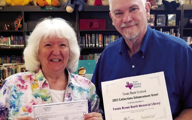 Library Director Sandra Davis (left) and Library Assistant Roy Davis display the Texas Book Festival grant check and certificate awarded recently to the Fannie Brown Booth Library in Center. (Submitted photo)