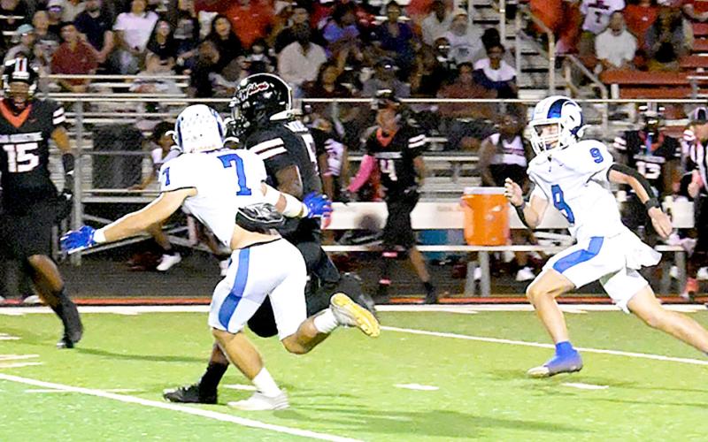 Joaquin’s Zachary Kelley and Jadyn Brown close in on a Wolf runner in action in the Ram’s game in San Augustine last Friday. Kelsi Wood | JHS