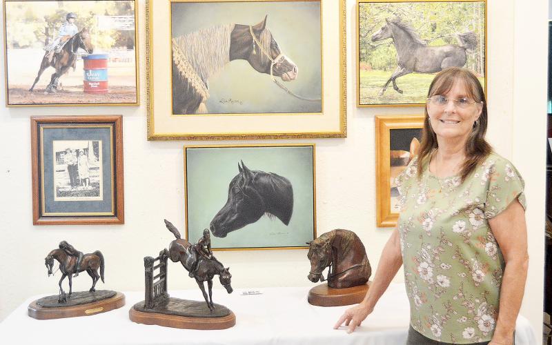 Lisa Myers displays some of her life’s work at the Shelby County Historical Museum where a show featuring Shelby County artists is ongoing. Myers has won many awards and honors for both her paintings and bronze work. David Danley | Light and Champion