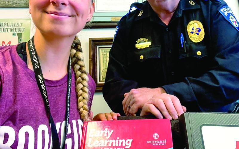 “Book Girl” snapped a photo with Center Police Captain Jeremy Bittick Monday, August 14 after he purchased educational books for his grandchildren.