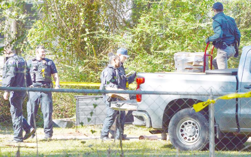 Officers with the Center Police Department load evidence gathered at the scene of an accidental death into the back of a pickup. Zack Clark | Light and Champion