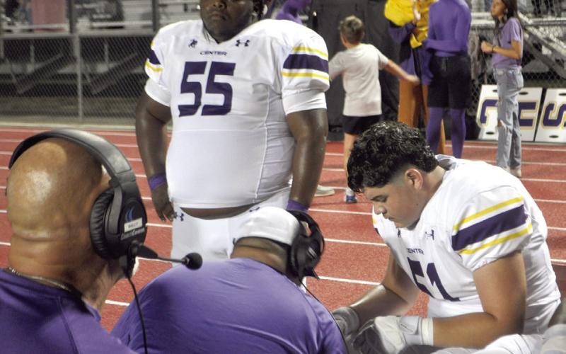 With their heads held high, the Center Roughrider defensive line gets some coaching during the meeting with rival Carthage last Friday night in Cartage. Dennis Phillips | Light and Champion