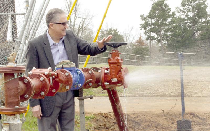 In a humorous gesture of providing proof of water flow from the new well, PWSC President Eric Garrett opened the valve for everyone to see. Leon Aldridge|The Light and Champion