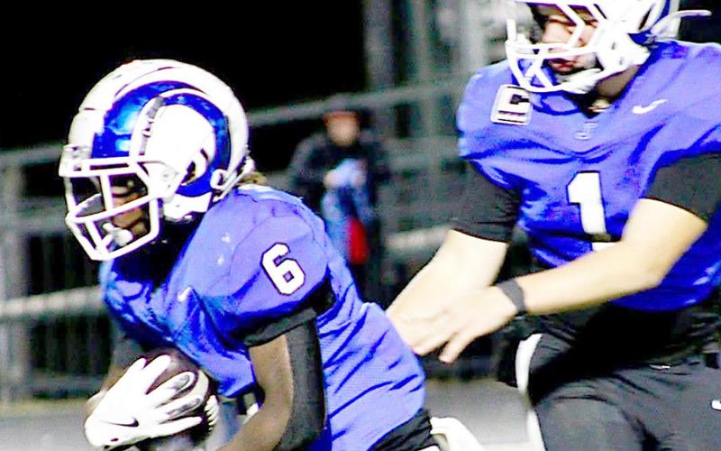 Running back Amarion Wilson (6) takes a handoff from quarterback Trenton Runnels in action in the Rams playoff contest with Elysian Fields. Wilson added 107 yards to the Rams dominant rushing attack against the Yellowjackets. Photo by Savannah Jordan JHS | Light and Champion