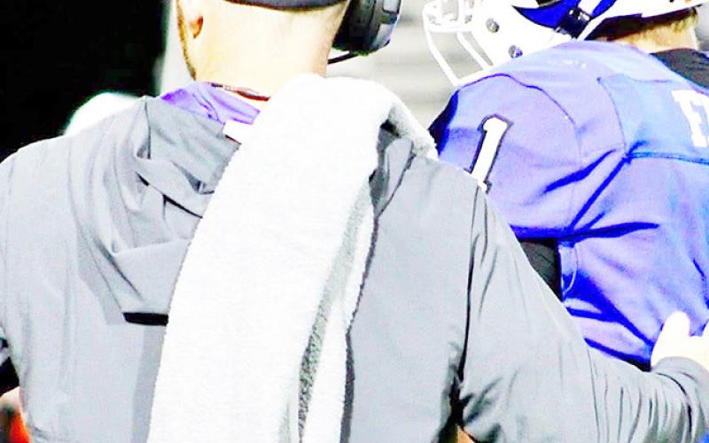Joaquin football’s head coach and AD Jared Jones consults with quarterback Trenton Runnels during the Rams’ 74-21 triumph over the Elysian Fields Yellowjackets Friday, Nov. 28. Savannah Jordan JHS | Light and Champion