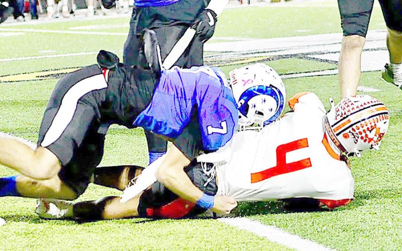Ram Zachary Kelley lays out Yellowjacket quarterback Nunu Kennedy in the teams’ playoff faceoff last Friday night. Kennedy managed to toss one touchdown over the course of the game, but the Rams retaliated by snagging three of his passes for interceptions. Savannah Jordan JHS | Light and Champion