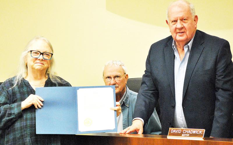 Mayor David Chadwick (right) presents Alease Copelin with a proclamation declaring 2026 the Year of the Volunteer while council member Howell Howard looks on at this week’s Center city council meeting. Zack Clark | Light and Champion