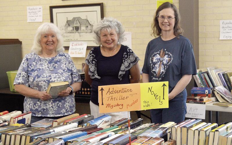 The Fannie Brown Booth Memorial Library is holding its Spring Book sale this week through Saturday. Lines formed around the building for opening day, but there are still plenty of books in all sorts of categories available. Assisting librarian Sandra Davis (left) with the sale on Wednesday were volunteers Tammy Lemoine (center) and Kim Oswalt. David Danley | Light and Champion