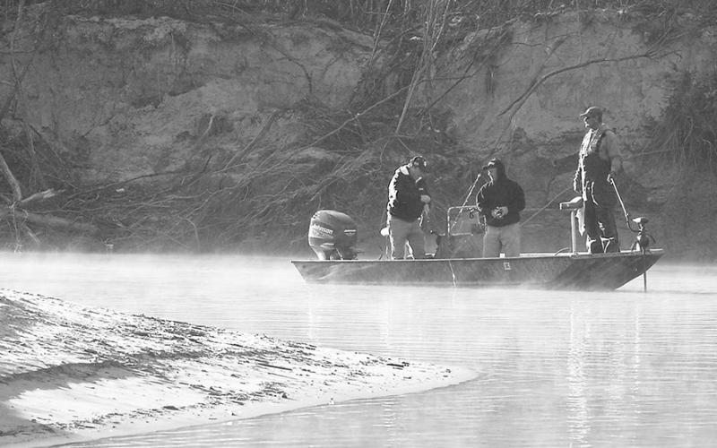 A trio of anglers go gunning for white bass along a sharp bend in the Sabine River on a crisp winter morning. Photo by Matt Williams