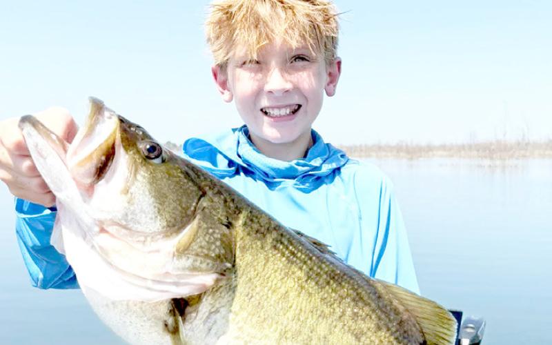 Caden Wilson with the 10.05 largemouth bass he boated on July 31 at Bois d’Arc Lake. Pending certification by TPWD, the fish will be the official junior angler lake record. Photo courtesy Jason Conn | Light and Champion