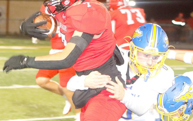 Shelbyville’s Bryant Scarborough tries to shake off a Carlisle defender in action last Friday night when the Dragons pulled off a 38-34 win. The Dragon Yearbook