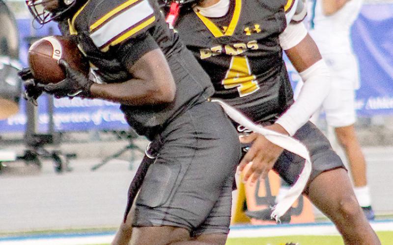 Albert Parker Jr. looks for a way to assist as a Bear runner tries to advance the ball against Wolfe City. TISD Student Media Intern Savannah Cassell