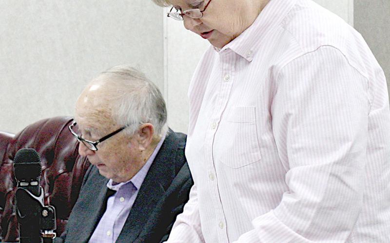 Shelby County Treasurer Ann Blackwell (right) reports to the commissioners court at last week’s meeting as County Attorney John Price (left) reviews notes. David Danley | Light and Champion