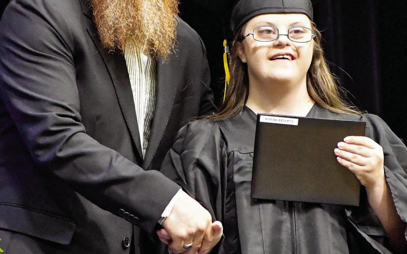 Claycee Renick basks in the moment as she participates in the Timpson High School Class of 2025’s graduation ceremony. Submitted | Light and Champion