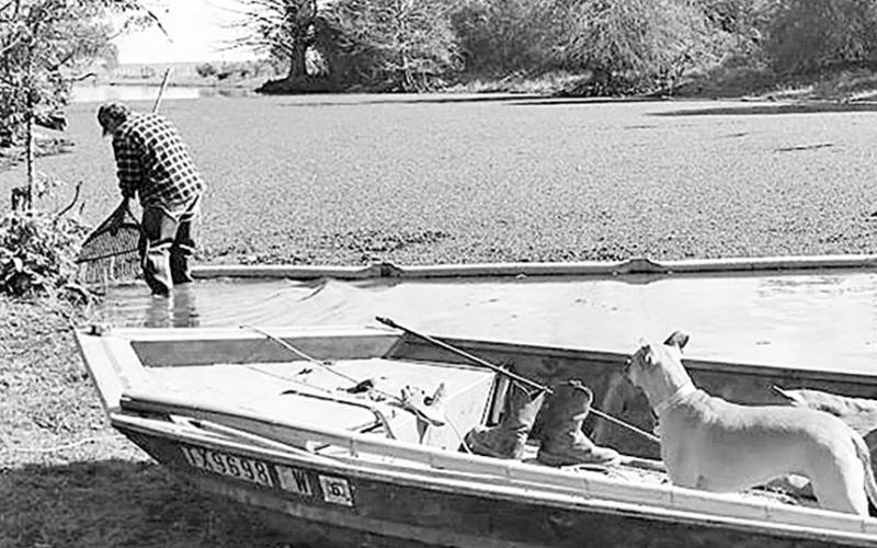 Charlie Shivley of Huxley strings booms across the channel that leads to his facility to prevent rafts of Giant salvinia from drifting in during fall 2024. Courtesy photo Rhonda Shivley