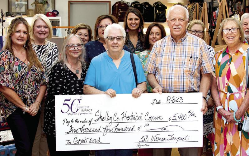 50 Women Impact presents checks to non-profits