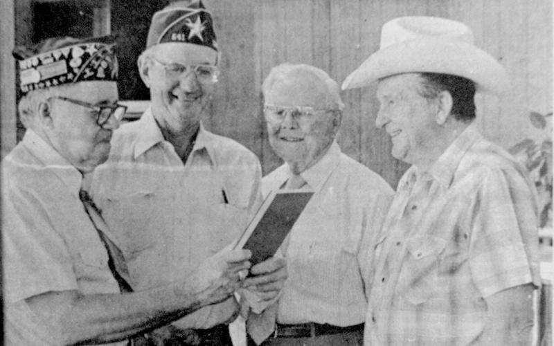 Charles Price (left) receives a service award from J.C. Morse, commander of Norman G. Crocker Post No. 541 of the American Legion. Looking on are Bill Bowlin and James Campbell.
