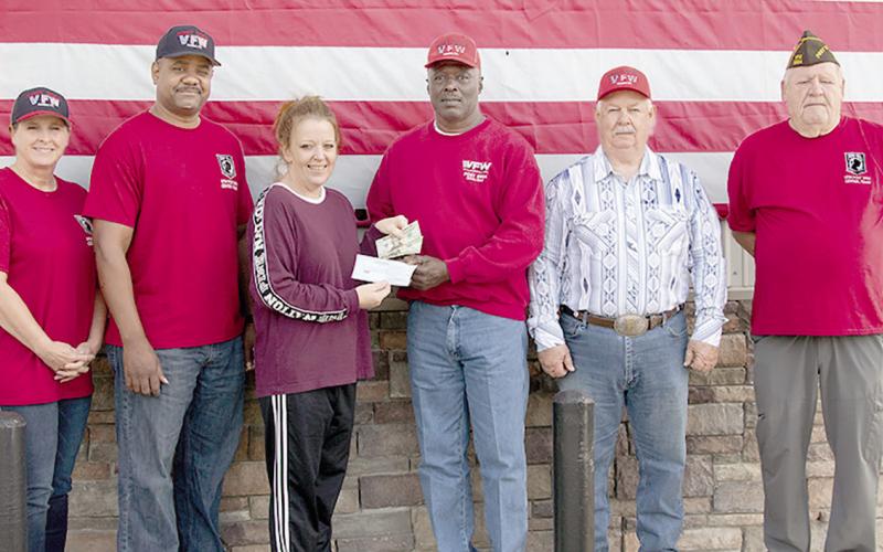 In honor of Veterans Day 2023, Pineywoods Beverage in Center donated recently to the Veterans of Foreign Wars Post 8904. Making the donation to Post Commander Richard Lundie is Pineywoods employee Jessica Hensarling. Other VFW members pictured are U.S. Army Retired Veteran Mary Roberts, U.S. Army Retired Veteran Derrick Roberts, U.S. Army Veteran Frank Hudspeth and U.S. Army Veteran Mike Wulf. Photo submitteßd by VFW Post 8904