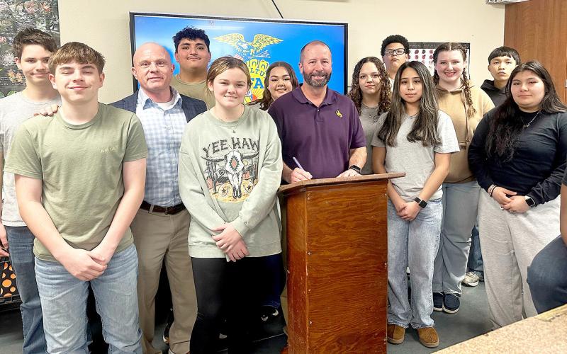 CISD Superintendent Jake Henson signs a proclamation declaring Feb. 21-28 National FFA Week. Center FFA students will be celebrating the week in various ways including a local food drive. Submitted | Light and Champion