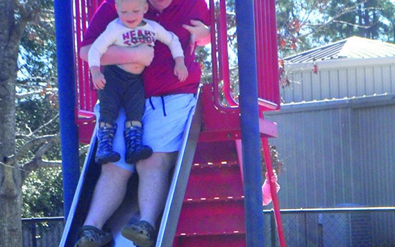 Alan is helped down the slide at Port-O-Cool park in Center by Kayden. Photo by Veronica Davis