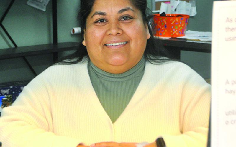 Judy Morales at Center Furniture tends to her job stopping long enough for this photo. Photo by Veronica Davis
