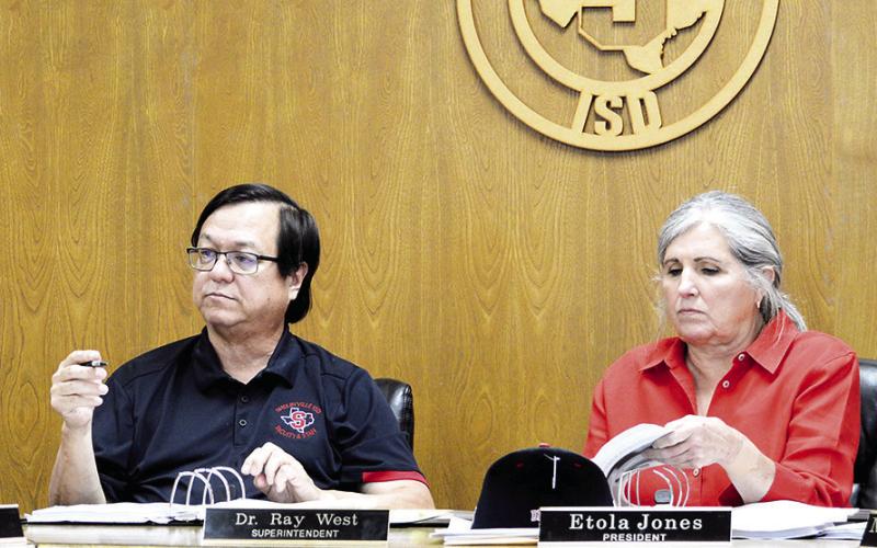 to the Shelbyville ISD board of directors while board president Etola Jones reviews information in the boards meeting packet. Dr. Ray West gives his superintendents report David Danley | Light and Champion