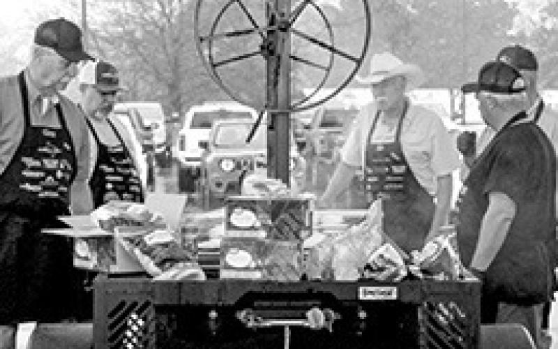 The Shelby County Cookers served hamburgers at the Wright Chrysler Dodge Jeep Ram 20th Anniversary celebration in Center Friday, March 1. Despite a downpour of rain, the event was well attended.