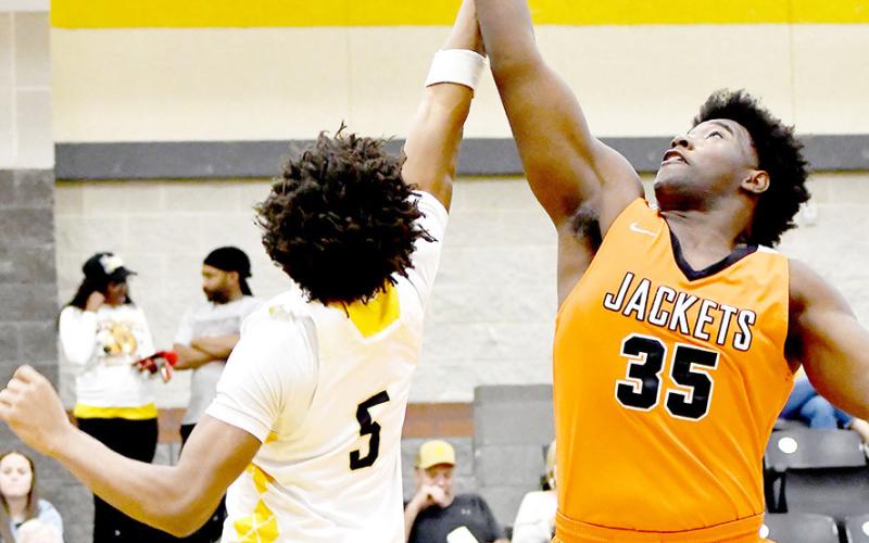 Timpson’s Albert Parker tangles with an Elysian Fields player in a struggle for a rebound during the Bears’ game against the Yellowjackets in a district game. Timpson ISD | Light and Champion