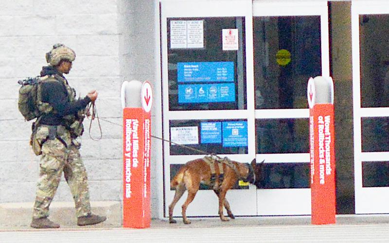 A member of the bomb disposal team from Barksdale Air Force Base prepares to enter the Center Walmart store with his canine to sweep the building for explosives. None were found and following a second sweep by a different canine the store was allowed to re-open. David Danley | Light and Champion