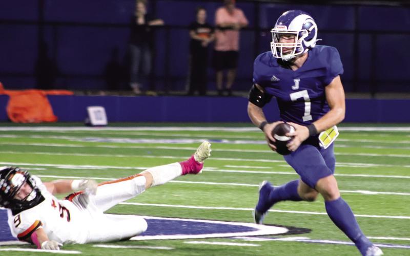 Senior Gauge Jordan rolls to his left seeking an open receiver down field. (Photo by Taylor Bragg)