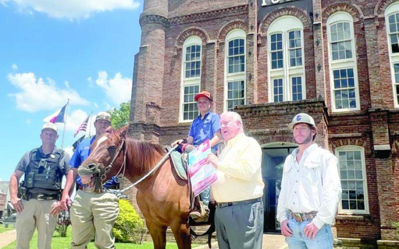 (left to right): Precinct 5 Constables J. Pope and Josh Tipton, Braxton, Mayor Chadwick, and Trey Box. Braxton delivered Timpson Frontier Days flyers through the Pony Express to surrounding towns on Friday, July 21, 2024.