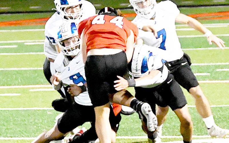Tate Obregon (44) of the Shelbyville Dragons is met by a squad of Joaquin Ram defenders in the two teams’ game last Friday. The Rams prevailed over their cross-county rival by a score of 34-10. Kelsi Wood | JHS