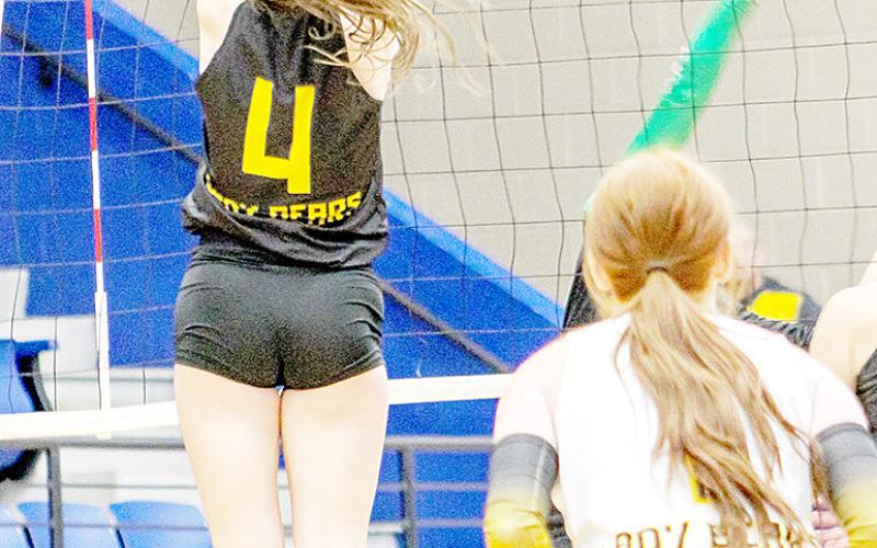 Paige Molloy, senior outside hitter, goes up for a block in a Lady Bears game against the Lady Tigers of Latexo. Savannah Cassell | Timpson ISD Student Media Intern