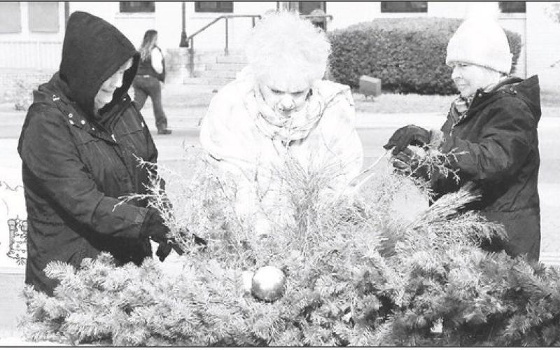Center Garden Club members (from left) Jennifer Wulf, Vicky Warren and Cherry Jones spruced up the flower boxes around the square earlier this week in anticipation of Center’s holiday celebrations. The annual lighting of the Christmas tree on the historic courthouse square was held Tuesday night and the town’s lighted Christmas parade will be held this Saturday at 6:00 p.m. Zack Clark | Light and Champion