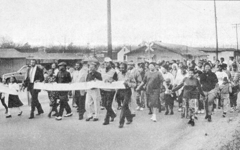 About 100 people marched down Martin Luther King Drive in Center Monday to celebrate the observance of Martin Luther King, Jr. Day across the nation. The march began at Boles Feed store and continued down King Drive until it reached Mt. Zion C.M.E. Church, which sponsored the event. There was a program after the march.