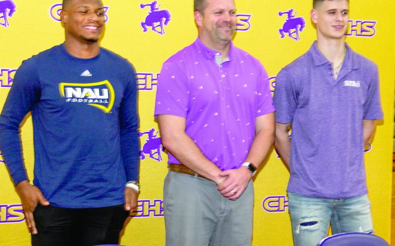 Center Roughriders Kaden Dixon (left) and Lance Wilburn (right) signed letters of intent Wednesday, Feb. 7 to play college football. Center Athletic Director and Head Coach Ricky Meeks (center) welcomed the crowd of students, family and friends, congratulating the two athletes. Leon Aldridge | The Light and Champion