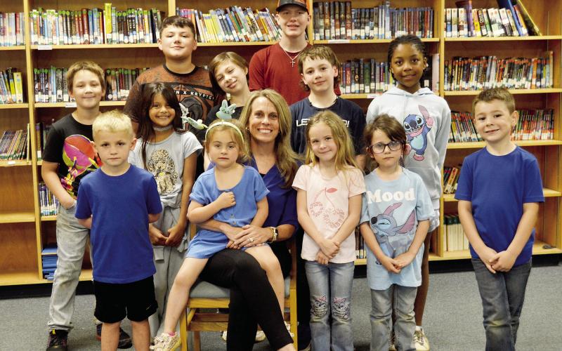 Principal Roni Waller is surrounded by some of Excelsior ISD’s students in the school’s library. The school has been experiencing significant growth recently and is poised for more exciting things to come. David Danley | Light and Champion