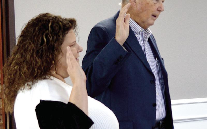 ABOVE: Gerald Corbell takes the oath of office to become the Shelby County Sheriff. RIGHT: Deborah Riley, Tax Assessor-Collector, and John Price, County Attorney swear in.