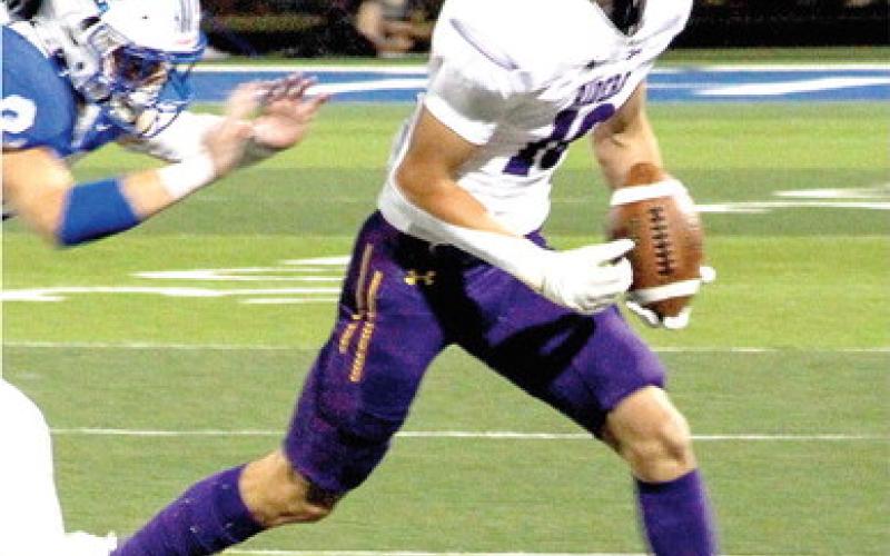 p Lance Wilburn looks for running room up the sideline. (Leon Aldridge photo/The Light and Champion)